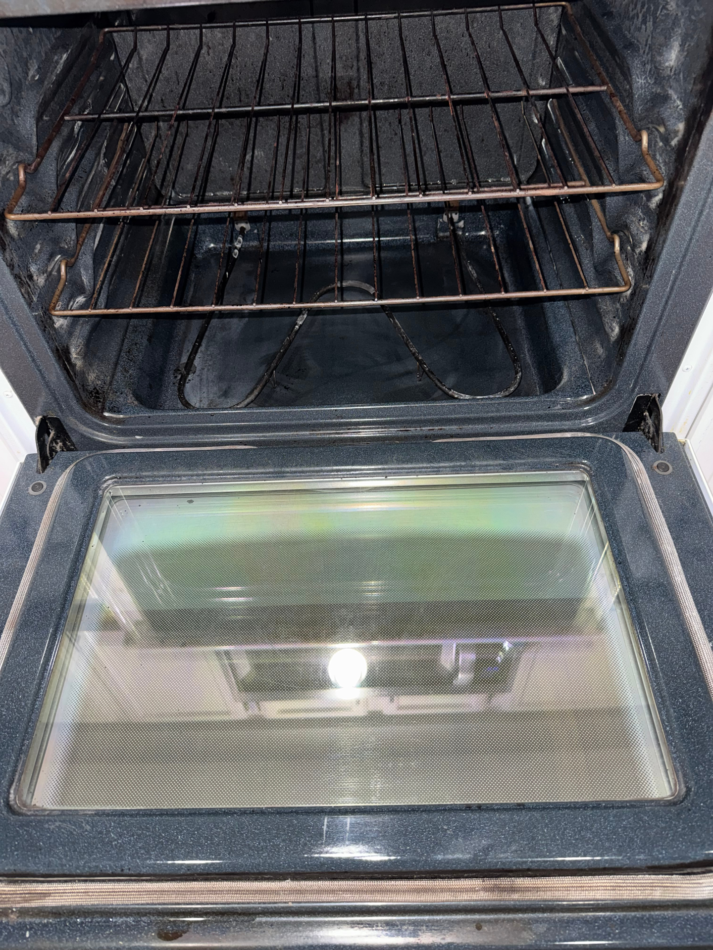 Oven door after cleaning, glass clear and streak-free