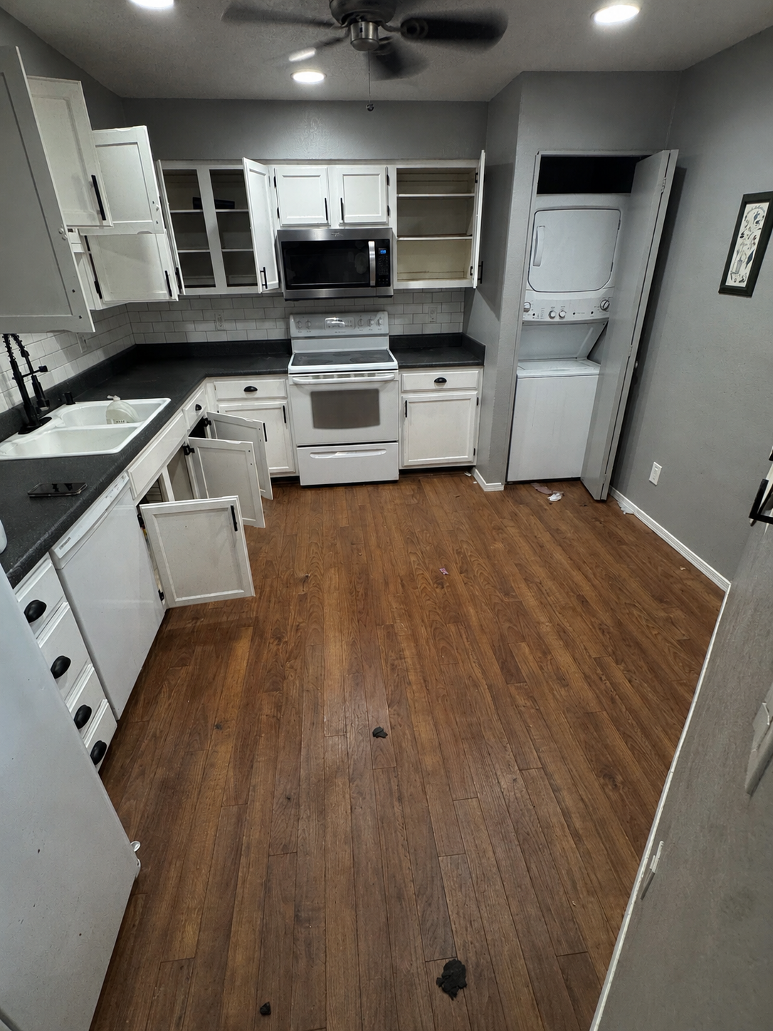 Kitchen before cleaning, with debris on the floor